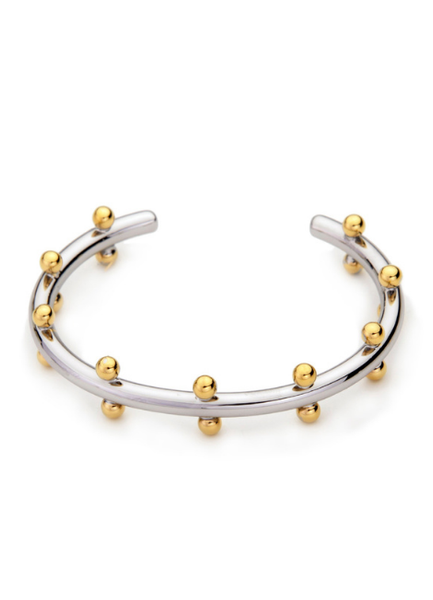 Add a touch of luxury with the Gloria Golden Drops Bangle, featuring a chic two-tone design in premium 18K gold plating. Minimal yet bold, it’s the perfect statement piece for any occasion.